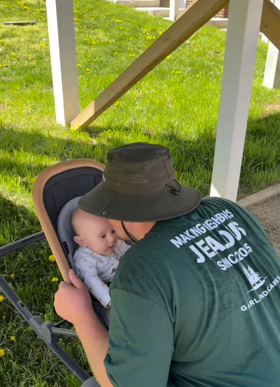 Garlandscapes family moment with baby under a porch