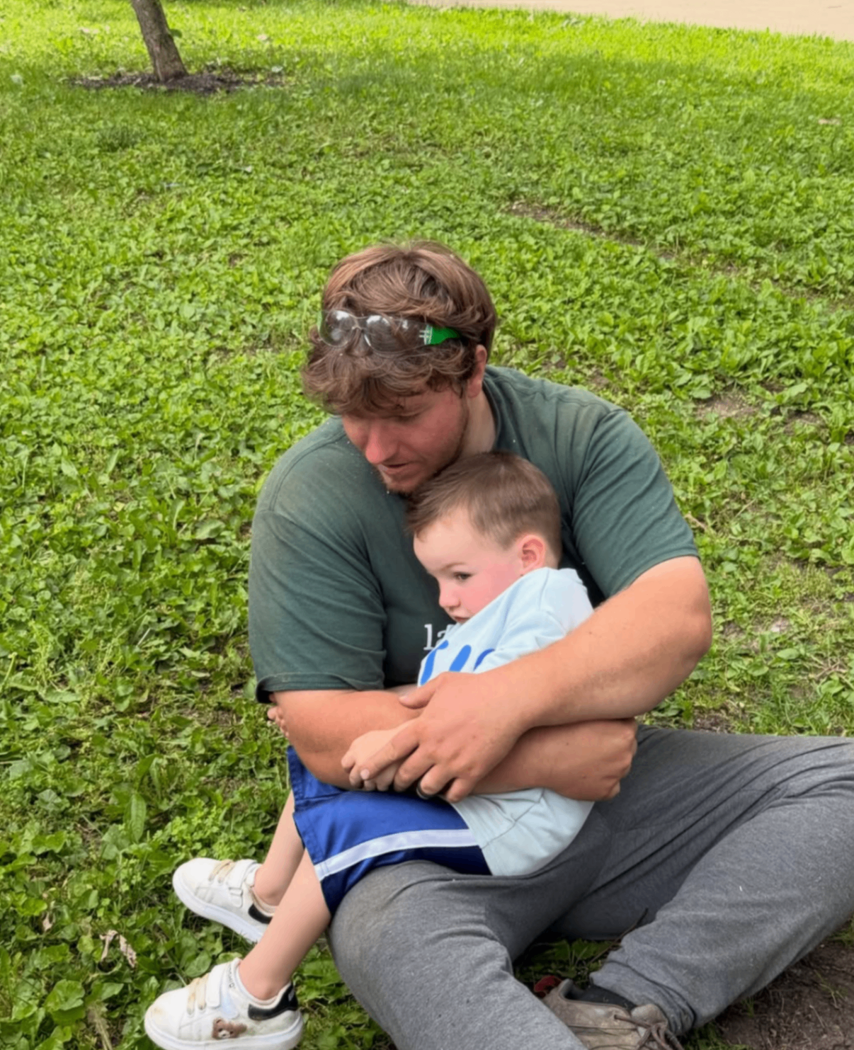 Garlandscapes team member sharing a family moment on the lawn